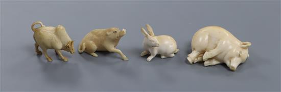 Four European ivory models of a sleeping piglet, a hare, an ox and a wild boar, early 20th century 3.4cm - 5.3cm